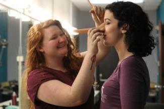 Students putting on makeup and props